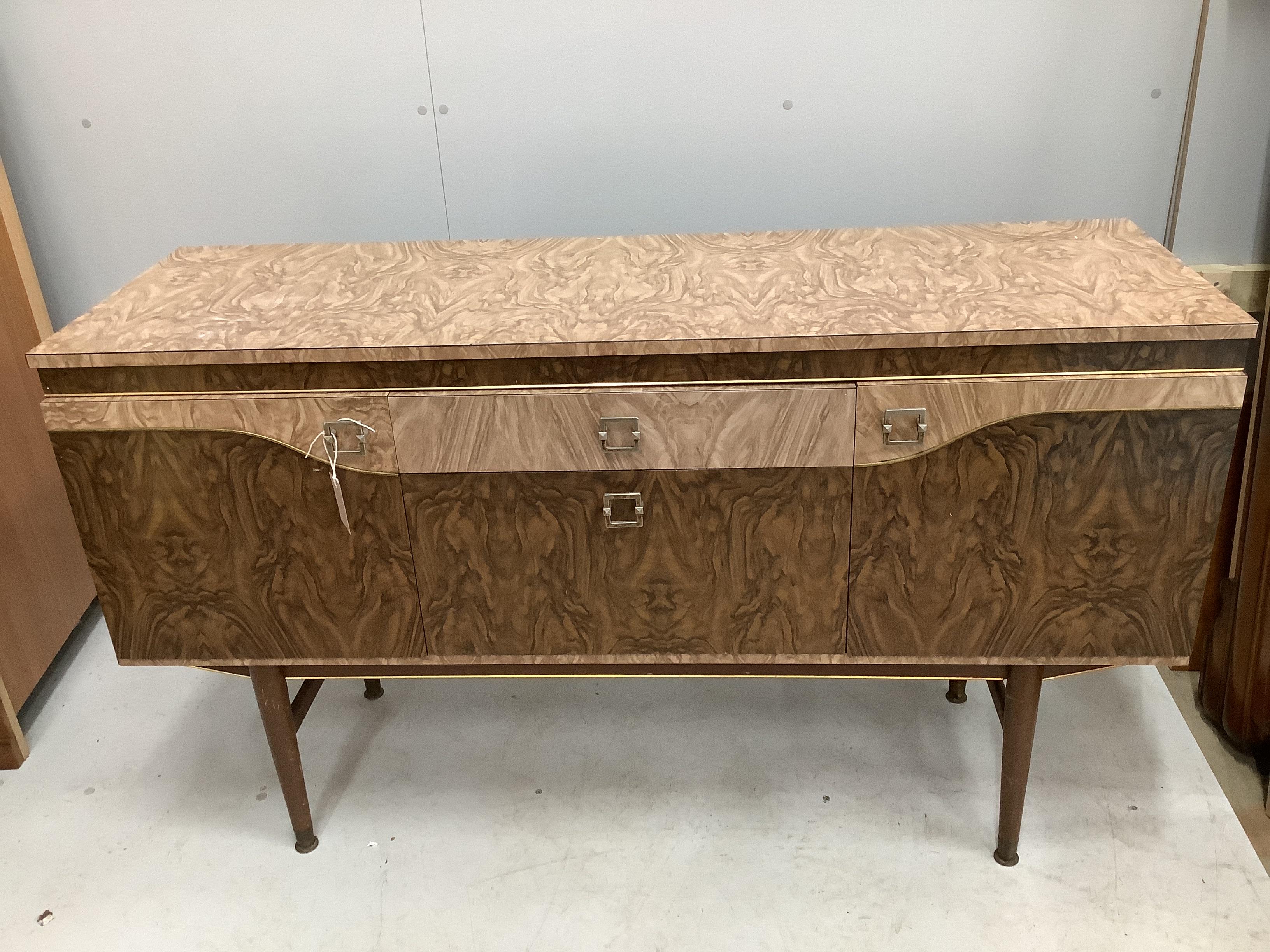 A 1960’s melamine sideboard, width 136cm, depth 43cm, height 78cm